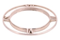 Tiffany & Co. - An Atlas Tapered bangle in silver, the closed round bangle set with Roman numerals to the cardinal points, signed and hallmarked, London 2014, inner diameter 6.5cm, 29.6 grams. No box. No papers.