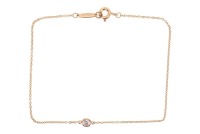 Tiffany & Co - A 'Diamonds by the Yard' bracelet in 18ct yellow gold, designed by Elsa Peretti, set with one round brilliant-cut diamond weighing 0.08ct, in a spectacle setting on a fine cable link chain, completed with spring-ring clasp, signed, London h