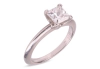 Tiffany & Co - a diamond solitaire ring, composed of a princess-cut diamond, with a carat weight of 0.87ct, and an estimated colour and clarity grade of H, VS2, in a four-prong setting, to a knife-edge shank in white metal stamped &lsquo;PT950&rsquo; and 'Tiffany & C