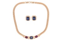Christian Dior - A gold-plated necklace and earrings suite, the necklace composed of three step-cut blue and pink paste, bezel set and flanked by paste-set accents, to a flat curb link chain, clasp with maker&rsquo;s mark, together with a pair of matching earri