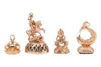 A Victorian gold and carnelian seal, foliate engraved seal with intaglio carved monogram, 23mm high; a further 9ct gold and chalcedony seal with a surmount of St George and the dragon, 37mm high; a modern 9ct gold and bloodstone seal in Victorian style an