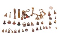 A large collection of over forty seals, mostly 19th century. Many stone set with engraved intaglios, three desk seals and a watch key mount; also including a gilt metal chain suspending four seals and a Victorian compass fob.