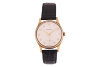 Garrard &ndash; A 9ct Gold Dress Watch Reference: 56757 Year: Hallmarked London 1976 Bezel: Smooth Case Material: 9ct Yellow Gold Case Diameter: Approximately 34mm Dial: Silvered, Pointed Baton Hands Numerals: Arabic, Minute Track Crown: Fluted Movement: Unites