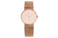 Longines &ndash; A 9ct Gold Dress Watch Reference: 14045 Year: Hallmarked London 1960 Bezel: Smooth Case Material: 9ct Yellow Gold Case Diameter: Approximately 32mm Dial: Silvered, Sunburst, Pointed Baton Hands Numerals: Baton Crown: Fluted Movement: Longines C