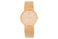 Corum &ndash; An &lsquo;18K&rsquo; Dress Watch Bezel: Smooth Case Material: &lsquo;18K&rsquo; Case Diameter: Approximately 32mm Dial: Gold-Tone, Sunburst, Crosshair, Pointed Baton Hands Numerals: Baton Crown: Fluted Movement: Manual Wind Strap: Integral Mesh Strap Inner Circumference: