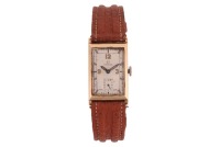 Omega &ndash; A Gentleman&rsquo;s Art Deco Wristwatch Year: circa 1935 Bezel: Smooth Case Material: Yellow Metal (Case marked with Swiss Squirrel mark indicating 14ct, stamped in Geneva) Case Diameter: Approximately 20mm x 30mm Dial: Silvered, Blued Pointed Baton Han