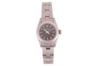 Rolex &ndash; A Lady&rsquo;s Oyster Perpetual Reference: 67180 Serial: 8420672 Year: Purchased 1991 Bezel: Smooth Case Material: Stainless Steel Case Diameter: Approximately 24mm Dial: Black, Baton Hands Numerals: Baton, Rolex Coronet at twelve o&rsquo;clock, Minute Track 