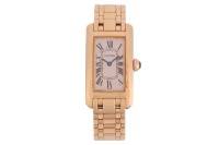 Cartier &ndash; An &lsquo;18K&rsquo; Tank Americaine Wristwatch Reference: 1710 Serial: CC83060 Bezel: Smooth Case Material: &lsquo;18K&rsquo; Case Diameter: Approximately 18mm x 26mm Dial: White, Signed at seven o&rsquo;clock, Blued Sword Hands Numerals: Black Roman Numerals, Minute Track 