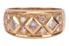 A diamond-set ring, of a chequerboard design, comprising three round brilliant-cut diamonds in square mounts, interspersed with smaller diamond accents, estimated total weight 0.38ct, in yellow metal stamped '750', size O, 5.49 grams. - 2