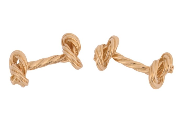 A pair of 'Marine knot' cufflinks in 18ct yellow gold, textured and terminated with nautical rope knot motifs, partial British hallmarks, overall measures 2.5 cm wide, the total weight of items 14.29 grams.