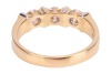 A diamond three-stone dress ring, with an estimated total diamond weight of 0.87ct, comprising three round brilliant-cut diamonds of 4.3mm, in a two-toned bar setting, leading to a tapering flat shank, Italian assay marks '750', size Q, 5.6 grams. - 3