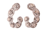 A pair of earrings set with old-cut diamonds, the scalloped hook-shaped mount, each illusion-set with six old-cut diamonds, with an estimated total weight of 2.16ct for the pair, fitted with post and a hinged back, unmarked white metal testing as 9ct, 2.8