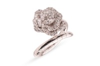 A diamond-set floral ring by Renu Oberoi, featuring a rose form, fully grain-set with round brilliant-cut diamonds, to an open white metal ring shank of bypass design, the shank with segmented detail, marked &lsquo;750&rsquo;, size L, boxed, 7.0 grams.