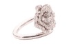 A diamond-set floral ring by Renu Oberoi, featuring a rose form, fully grain-set with round brilliant-cut diamonds, to an open white metal ring shank of bypass design, the shank with segmented detail, marked &lsquo;750&rsquo;, size L, boxed, 7.0 grams. - 4