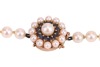 A cultured pearl necklace with gem-set clasp in 9ct gold, comprising a strand of round cultured pearls of 6.0 mm, hand-knotted to a cluster box clasp set with circular-cut sapphires and cultured pearls, British assay marks, overall length 50.0 cm, 30.4 gr - 2
