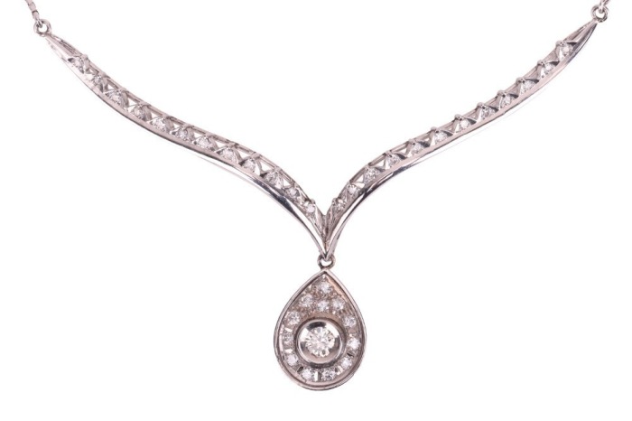 A diamond-set necklace, composed of a V-shaped bar, with diamond-set chevron detailing, suspending a pear-shaped diamond-set pendant, to a box-link chain measuring approximately 42cm, in white metal stamped &lsquo;585&rsquo;; 8.4 grams
