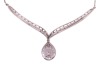 A diamond-set necklace, composed of a V-shaped bar, with diamond-set chevron detailing, suspending a pear-shaped diamond-set pendant, to a box-link chain measuring approximately 42cm, in white metal stamped &lsquo;585&rsquo;; 8.4 grams - 3