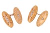 A pair of diamond-set cufflinks, of elongated oval form with repousse design, one panel centred with a star-set old-cut diamond, the other pave-set with a row of three old-cut diamonds in a navette mount, connected by a figure of eight link, unmarked yell