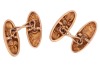 A pair of diamond-set cufflinks, of elongated oval form with repousse design, one panel centred with a star-set old-cut diamond, the other pave-set with a row of three old-cut diamonds in a navette mount, connected by a figure of eight link, unmarked yell - 2