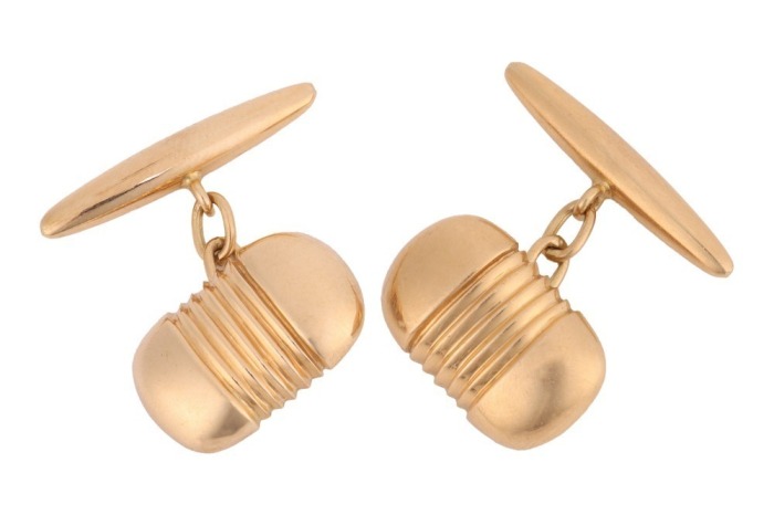 A pair of oblong cufflinks, with reeded details at the centre, fitted with linked torpedo backs, yellow metal marked '18ct', total weight of items 9.61 grams.