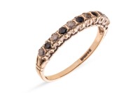 A sapphire and paste-set half-hoop ring, claw-set in an alternating pattern, to a 9ct gold mount, size Q; 1.8 grams