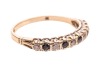 A sapphire and paste-set half-hoop ring, claw-set in an alternating pattern, to a 9ct gold mount, size Q; 1.8 grams - 4