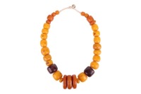 A Moroccan Berber necklace, comprising a single string of large pressed amber beads, of graduated barrel-shape in butterscotch colour, largest measuring 3.5 x 3.0 cm, overall length 67.0 cm, 458.5 grams.