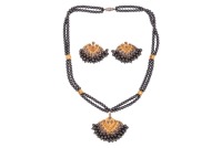 A hematite bead necklace and earrings suite; the Mughal-style necklace pendant featuring a cluster of hematite beads to the base, leading to a double-row necklace of hematite beads, interspersed with faceted gilt spacers, to a base metal screw clasp, toge
