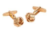 A pair of knot cufflinks, in yellow metal marked &lsquo;750&rsquo;, the textured knots leading to toggle fittings, with a cross-hatch pattern; 12.6 grams