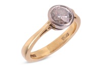 A diamond solitaire ring, with a round brilliant-cut diamond measuring approximately 5.6mm, with an estimated carat weight of 0.65ct, in a white metal bezel setting, to tapered shoulders leading to a court-shaped shank, in 18ct yellow gold, hallmarked Lon