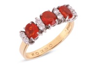 A fire opal and diamond half-hoop ring in 18ct gold, comprising three oval-cut fire opals, interspersed with round brilliant-cut diamond accents, to a flat shank, British hallmarks, size N, 3.4 grams.