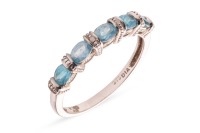 A topaz half-hoop ring in 9ct white gold, comprising five oval-cut topazes, in a bar setting with millgrain details and two diamond accents, British assay marks, size P, 2.0 grams.