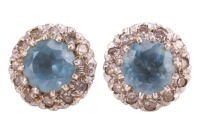 A pair of aquamarine and diamond stud earrings, each centred with a circular-cut aquamarine of 5.8 mm, surrounded by single-cut diamonds, peg and butterfly fittings, in white metal surface testing as 9ct, 2.9 grams. Please note: Unless otherwise stated, l