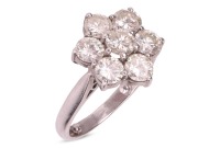 A diamond floral cluster ring in 18ct white gold, with an estimated total diamond weight of 2.15ct, the daisy head cluster comprising seven round brilliant-cut diamonds of 4.4mm, claw-set between tapered shoulders, British assay marks 2000, ring head 1.5c