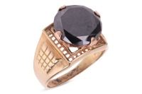A black diamond solitaire ring, comprising a large round brilliant-cut black diamond measuring 15.0 mm in diameter, claw-set to a pierced square mount, to a wide tapering shank, in unmarked yellow metal testing as 9ct, size Z+1, 11.4 grams. Please note: U