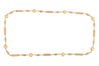 A long fancy link necklace, comprising a series of hollow links, alternating with a torpedo-shaped link, a tubular link and a spherical ball interval, in brush finish, completed with a conforming box clasp, yellow metal stamped 'Italy 18k', 75.0 cm long, 