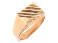 A signet ring, the rectangular head with diagonally striated design, tapering to a flat shank, yellow metal stamped '750', size Z+1, 20.2 grams.