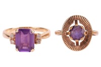Two amethyst-set rings, the first featuring a step-cut amethyst flanked by four round brilliant diamonds, to an unmarked yellow metal mount, surface tested as 14ct gold, size M, together with an amethyst-set target ring, in a 9ct yellow gold mount, size G