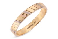 A wedding band in 18ct tri-coloured gold, the flat band with diagonal stripes alternating yellow, pink and white gold, British hallmarks, size Y&frac12;, 5.1 grams. Multiple metal splits, would need care and attention