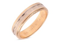 A bi-coloured wedding band, with a recessed faceted band in the middle, edges engraved with a geometric design, personal message engraved inside the shank, stamped '18K', size Q, 5.9 grams.