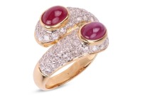 A gem-set crossover ring, each terminal bezel-set with two ruby cabochons, pav&eacute;-set with round brilliant diamonds to the shoulders, in yellow metal marked &lsquo;18K&rsquo;, size L1/2; 6.7 grams