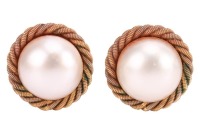 A pair of mab&eacute; pearl earrings, each centred with a cultured mab&eacute; pearl measuring approximately 3.6mm across, in textured twist surround, with post fittings and ear clips to the reverse, in 18ct yellow gold, hallmarked Sheffield, 1998; 12.6 grams