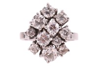 A diamond-set cluster ring, composed of eleven round brilliant-cut diamonds, of graduated sizes, with an estimated total carat weight of 2.04ct, claw-set in a stepped asymmetrical design, to a flat-shaped white metal shank, marked &lsquo;18ct&rsquo;, size I with bead