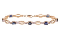 A sapphire-set bracelet, composed of seven oval mixed-cut sapphires, interspersed by open oval-shaped links, leading to a lobster clasp, in yellow metal marked &lsquo;14K&rsquo;, measuring approximately 18.3cm; 7.8 grams