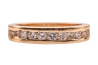 A diamond half-eternity ring, featuring a channel of twelve round brilliant-cut diamonds of graduating sizes, to a ring shank marked &lsquo;750&rsquo;, size I, 3.1 grams.