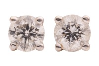A pair of diamond stud earrings, each claw-set with a round brilliant-cut diamond of 3.0 mm, with an estimated total weight of 0.20ct for the pair, fitted with ear posts and screw-on backs, in white metal marked '14K', 0.8 grams.