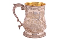 A George III silver baluster tankard, London 1768, probably by William Tuite, with later embossed flowering censer decoration, the leaf-capped handle supported on a similarly decorated spreading disk foot. housed in a tooled Morocco leather travel case. 1