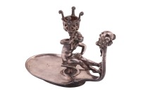Joseph Cheret. A pewter chamberstick, with figural mask carrying handle and oval-shaped dish, the nozzle supported by a cast cherub. 15.5cm high x 18cm wide. Signed and numbered; 'Joseph Cheret' and with a foundry mark 'Soleau Paris 1894.'