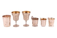 A group of silver and white metal beakers, cups and goblets, including a heavy gauge modern beaker of plain form, 27.9 ozt/ 869 grams combined weight of white metal and marked silver items.