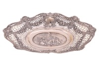An early 20th century, lozenge form (800) white metal fruit bowl/dish, probably German C1900, with pierced and embossed rim, the sole with repouse cherubs. 19.9 ozt/ 620 grams, 41.5 cm long x 28 cm wide.